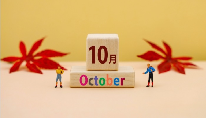 「10月」と「October」と書かれた木製カレンダーが中央に置かれている秋をイメージさせるシンプルで温かみのあるデザイン